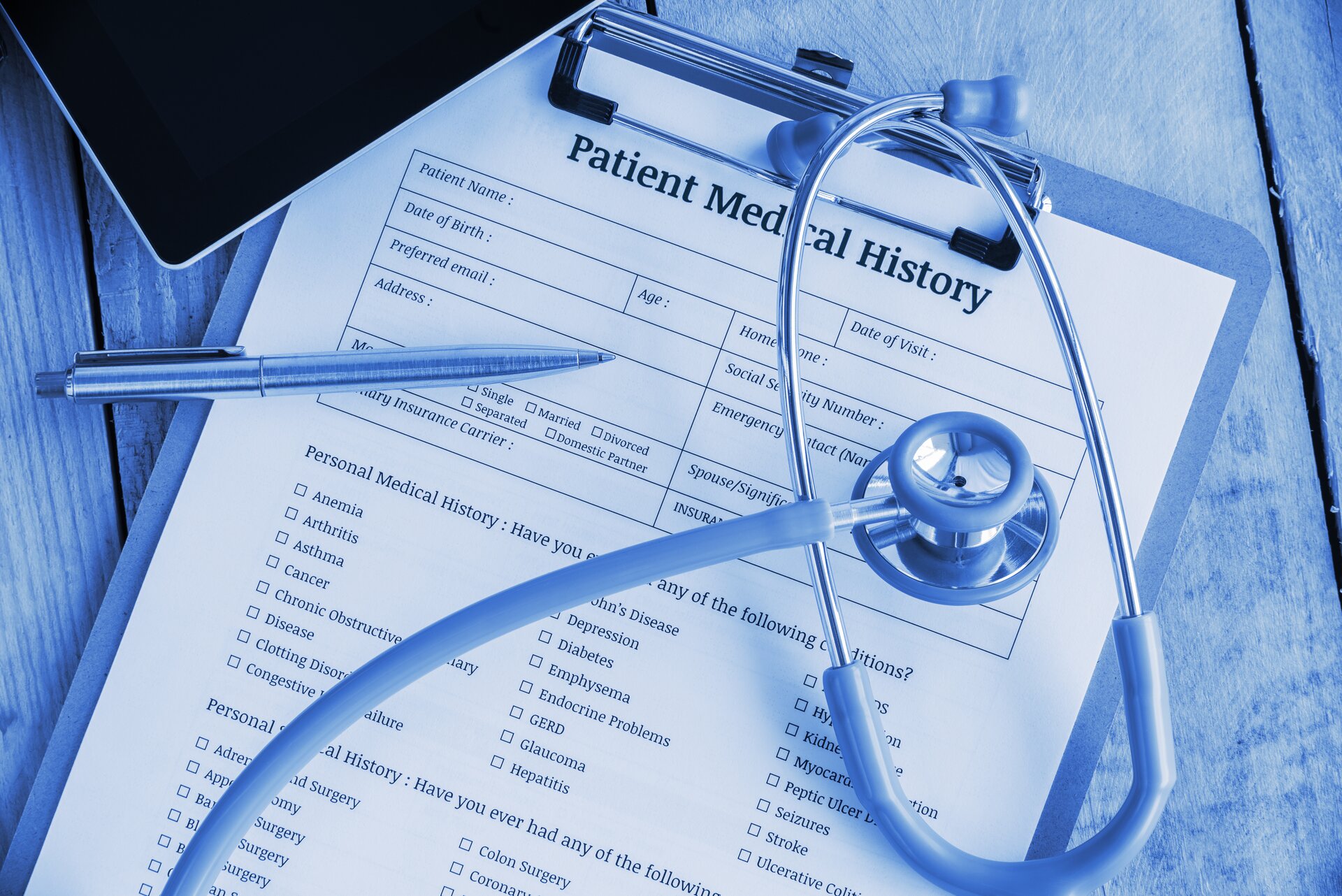 stock-photo-patient-medical-history-on-a-clipboard-with-stethoscope-and-a-blue-ballpoint-pen-putting-on-a-414285820